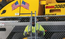 construction worker locking up project site