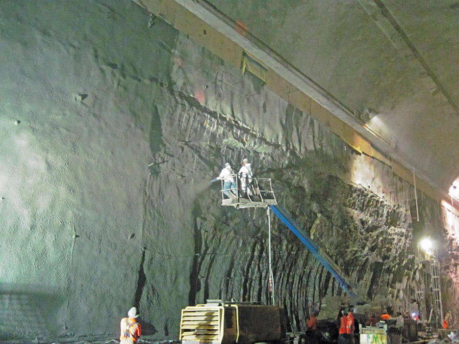 Workers apply shotcrete